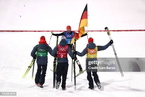 Johannes Rydzek of Germany celebrates winning gold with team mates Vinzenz Geiger of Germany, Fabian Riessle of Germany and Eric Frenzel of Germany...