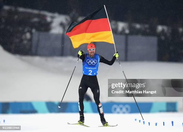 Johannes Rydzek of Germany celebrates winning gold during the Nordic Combined Team Gundersen LH/4x5km, Cross-Country on day thirteen of the...