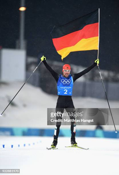 Johannes Rydzek of Germany celebrates winning gold during the Nordic Combined Team Gundersen LH/4x5km, Cross-Country on day thirteen of the...