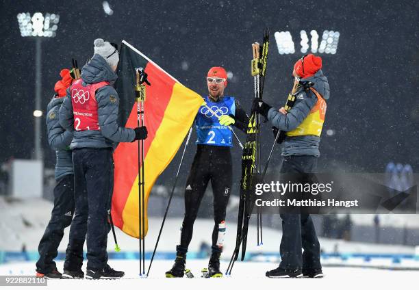 Johannes Rydzek of Germany celebrates winning gold with team mates Vinzenz Geiger of Germany, Fabian Riessle of Germany and Eric Frenzel of Germany...