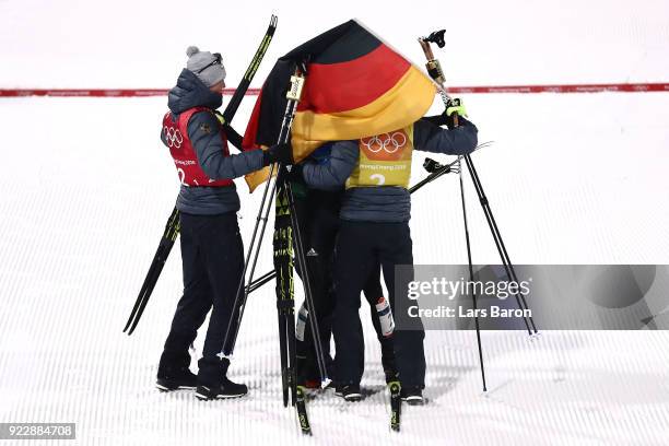 Johannes Rydzek of Germany celebrates winning gold with team mates Vinzenz Geiger of Germany, Fabian Riessle of Germany and Eric Frenzel of Germany...