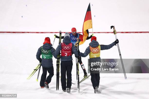 Johannes Rydzek of Germany celebrates winning gold with team mates Vinzenz Geiger of Germany, Fabian Riessle of Germany and Eric Frenzel of Germany...