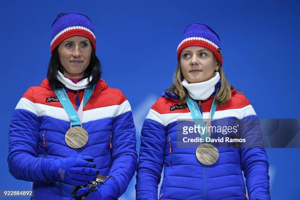 Bronze medalists Marit Bjoergen and Maiken Caspersen Falla of Norway stand on the podium during the medal ceremony for Cross-Country Skiing - Ladies'...