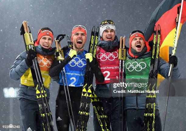 Johannes Rydzek of Germany, Vinzenz Geiger of Germany, Fabian Riessle of Germany and Eric Frenzel of Germany celebrate winning gold during the Nordic...