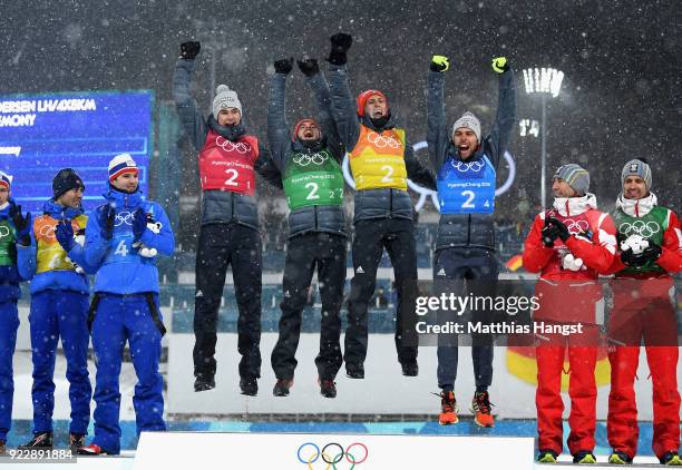 Gold medalists Vinzenz Geiger of Germany, Fabian Riessle of Germany, Eric Frenzel of Germany and Johannes Rydzek of Germany celebrate during the...