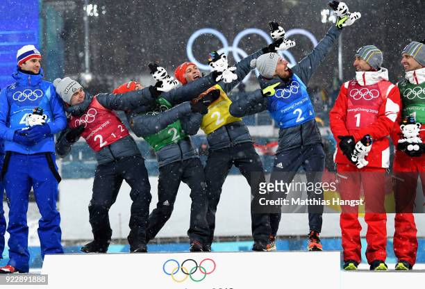 Gold medalists Vinzenz Geiger of Germany, Fabian Riessle of Germany, Eric Frenzel of Germany and Johannes Rydzek of Germany celebrate during the...