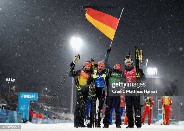 Johannes Rydzek of Germany, Vinzenz Geiger of Germany, Fabian Riessle of Germany and Eric Frenzel of Germany celebrate winning gold during the Nordic...