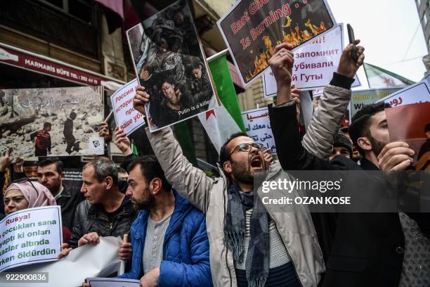 Protesters chant slogans and wave former Syrian "independence flags" in front of the Russian Consulate in Istanbul on February 22 during a protest...