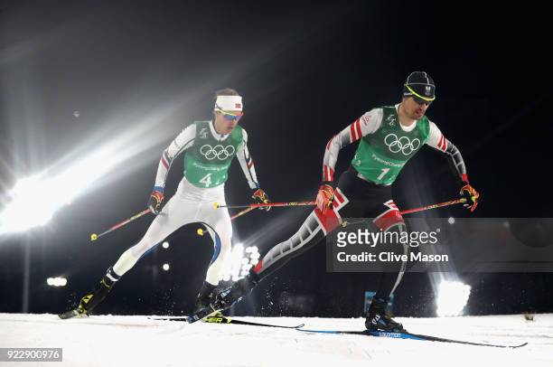 Espen Andersen of Norway and Lukas Klapfer of Austria compete during the Nordic Combined Team Gundersen LH/4x5km, Cross-Country on day thirteen of...