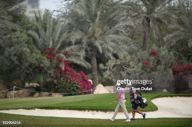 Daniel Brooks of England walks with his caddie during the first round of the Commercial Bank Qatar Masters at Doha Golf Club on February 22, 2018 in...