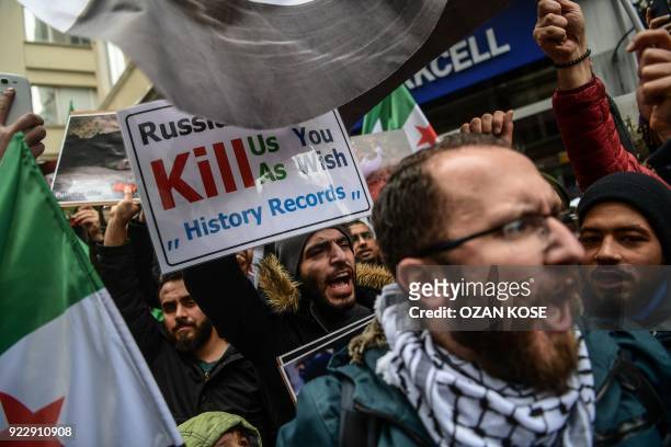 Protesters chant slogans and wave former Syrian "independence flags" in front of the Russian Consulate in Istanbul on February 22 during a protest...