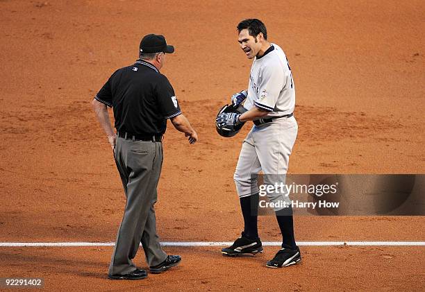 Johnny Damon of the New York Yankees argues a call with first base umpire Dale Scott at the end of the third inning in Game Five of the ALCS against...