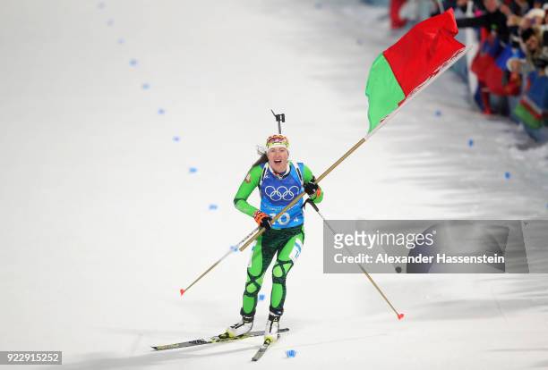 Darya Domracheva of Belarus celebrates as she appraoches the line to win gold during the Women's 4x6km Relay on day 13 of the PyeongChang 2018 Winter...