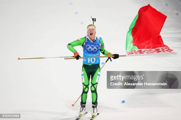 Darya Domracheva of Belarus celebrates as she approaches the finish line to win gold during the Women's 4x6km Relay on day 13 of the PyeongChang 2018...