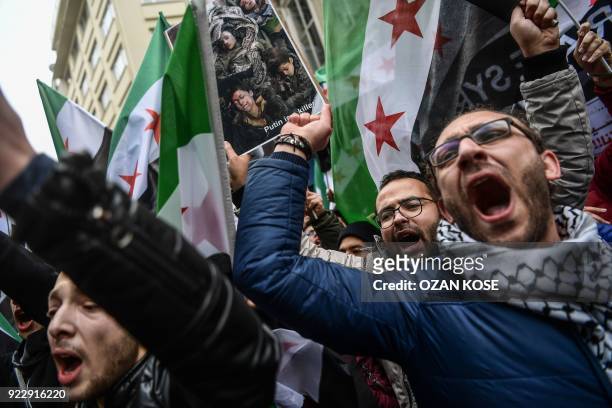 Protesters chant slogans and hold a placard reading 'Putin is a killer' in front of the Russian Consulate in Istanbul on February 22 during a protest...