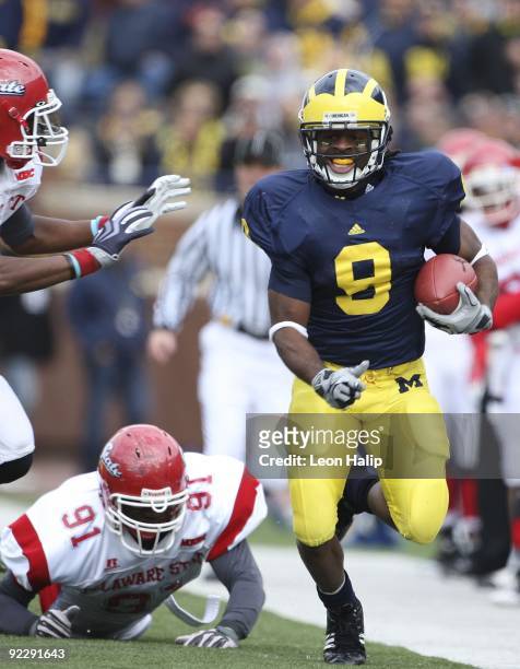 Martavious Odoms of the Michigan Wolverines runs for a first down in the second quarter against the Delaware State Hornets at Michigan Stadium on...