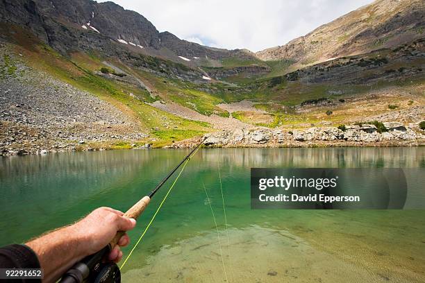 man flyfishing high mountain lake - wonderlust2015 stock pictures, royalty-free photos & images