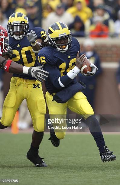 Denard Robinson of the Michigan Wolverines runs for a first down in the second quarter against the Delaware State Hornets at Michigan Stadium on...