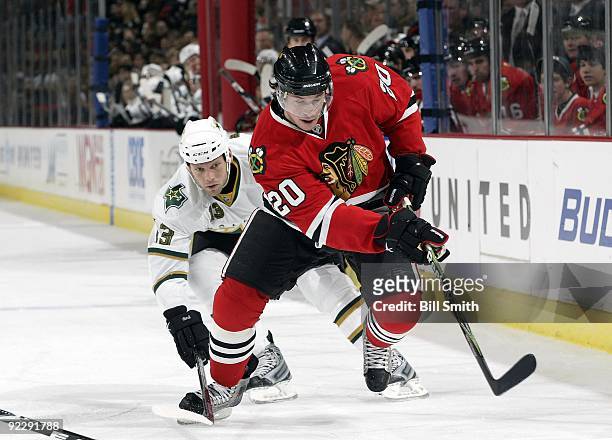 Jack Skille of the Chicago Blackhawks chases after the puck as Krystofer Barch of the Dallas Stars reaches from behind on October 17, 2009 at the...