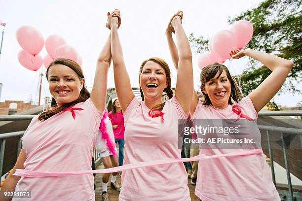 women run in breast cancer marathon - marathon ziel stock-fotos und bilder