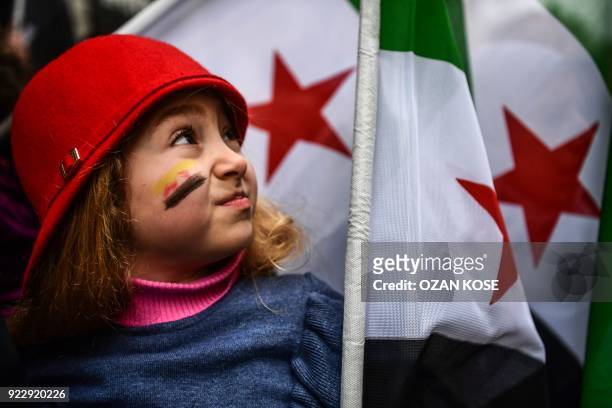 Girl holds a Syrian former independence flag in front of Russian Consulate in Istanbul on February 22, 2018 during a protest against the airstrikes...