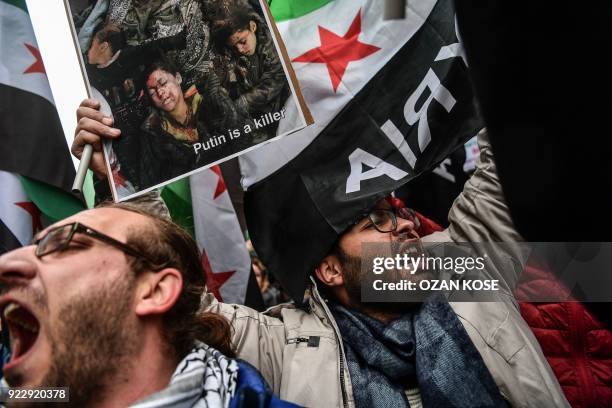 Protesters chant slogans and hold a placard reading 'Putin is a killer' in front of the Russian Consulate in Istanbul on February 22 during a protest...