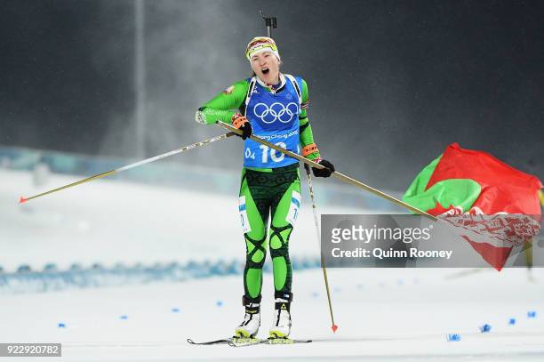 Darya Domracheva of Belarus celebrates with a flag as she wins gold during the Women's 4x6km Relay on day 13 of the PyeongChang 2018 Winter Olympic...