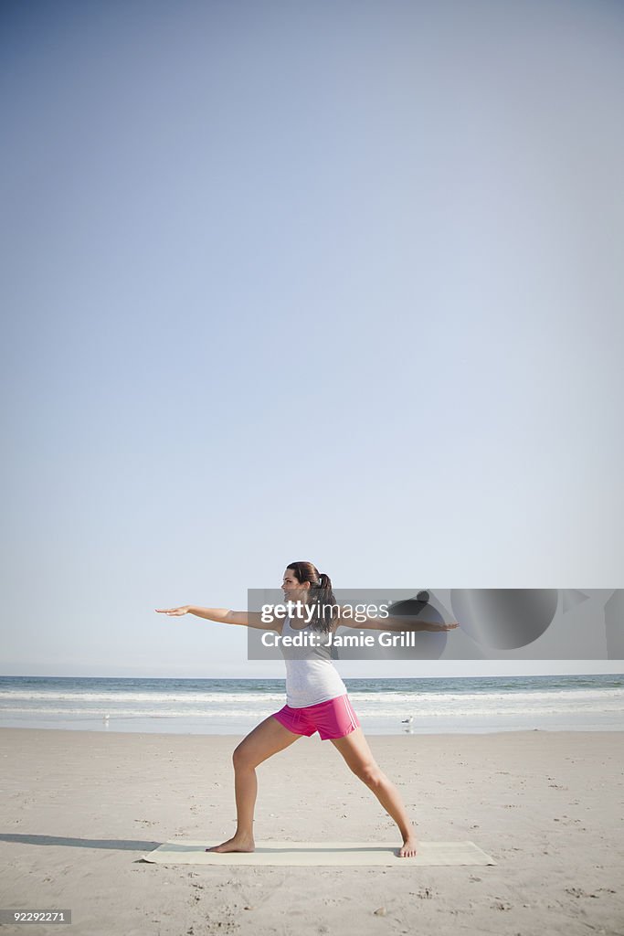 Woman doing yoga on beach