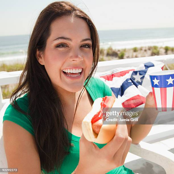 young woman at barbeque  - beach barbeque fotografías e imágenes de stock