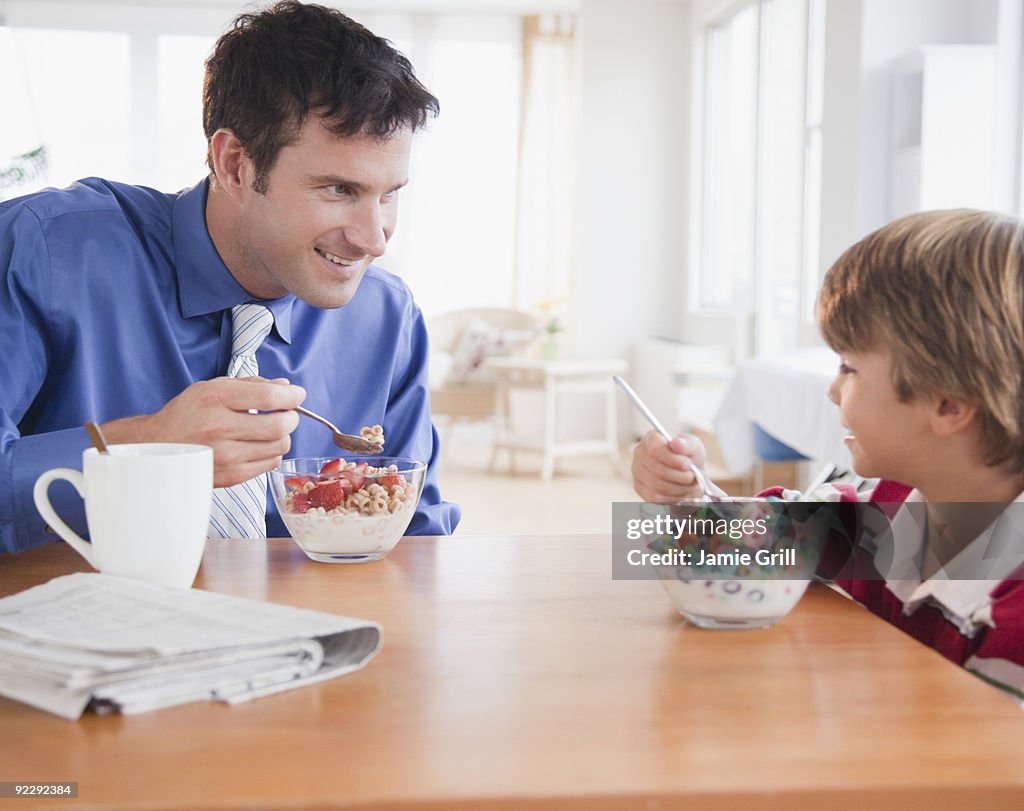 Father and son eating breakfast together