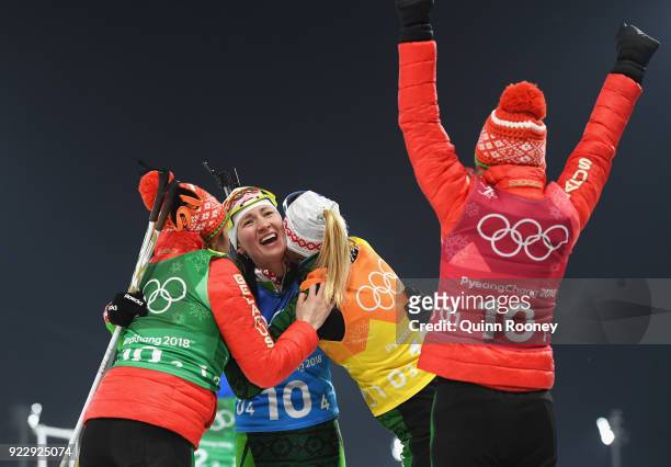 Darya Domracheva of Belarus celebrates winning gold with Iryna Kryuko, Dzinara Alimbekava and Nadezhda Skardino of Belarus during the Women's 4x6km...