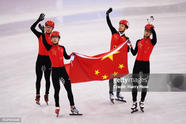 Dajing Wu, Tianyu Han, Hongzhi Xu and Dequan Chen of China celebrate winning the silver medal during the Short Track Speed Skating Men's 5,000m Relay...