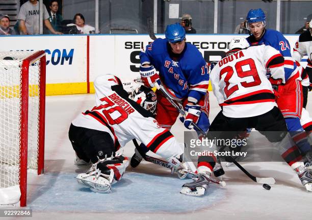 Martin Brodeur of the New Jersey Devils defends the net against Brandon Dubinsky of the New York Rangers on October 22, 2009 at Madison Square Garden...