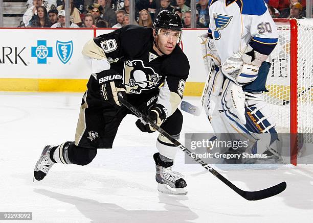 Pascal Dupuis of the Pittsburgh Penguins skates for a loose puck against the St. Louis Blues on October 20, 2009 at Mellon Arena in Pittsburgh,...