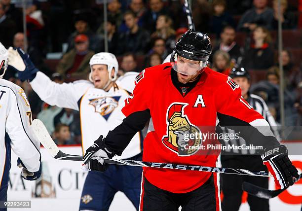 Mike Fisher of the Ottawa Senators skates away dejected while Shea Weber of the Nashville Predators celebrates his game winning overtime goal in a...