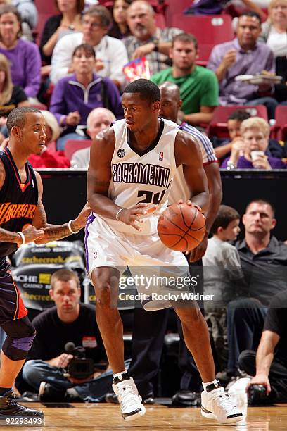 Desmond Mason of the Sacramento Kings moves the ball against Stephen Curry of the Golden State Warriors during a preseason game at Arco Arena on...