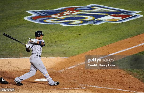 Robinson Cano of the New York Yankees hits a two run triple to right field during the seventh inning in Game Five of the ALCS against the Los Angeles...