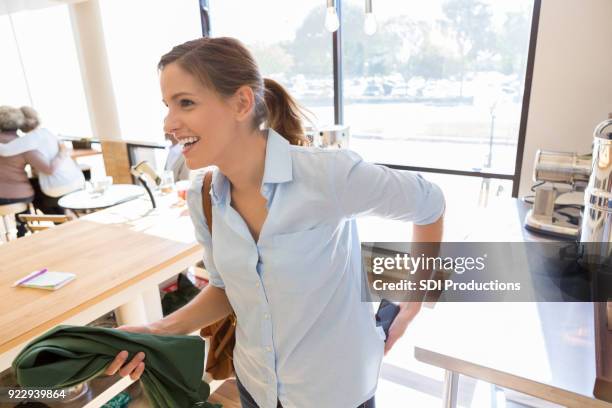 happy waitress leaving coffee shop after her shift - leaving restaurant stock pictures, royalty-free photos & images