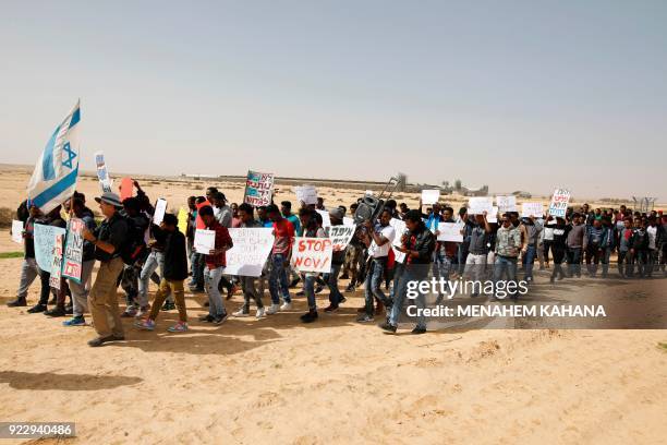 African migrants march from Holot detention centre to the Saharonim Prison, an Israeli detention facility for African asylum seekers, where at least...