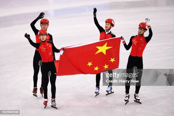 Dajing Wu, Tianyu Han, Hongzhi Xu and Dequan Chen of China celebrate winning the silver medal during the Short Track Speed Skating Men's 5,000m Relay...