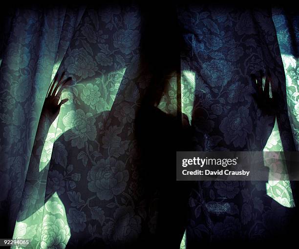 woman behind curtain dark - behind the curtain stock pictures, royalty-free photos & images