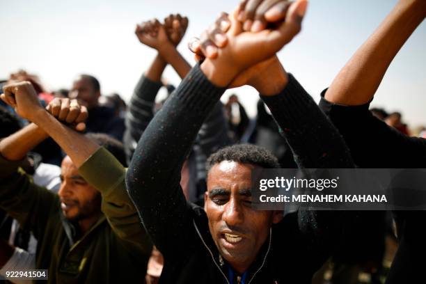 African migrants protest outside the Saharonim Prison, an Israeli detention facility for African asylum seekers near Kziot, against the incarceration...