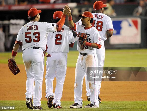 Maicer Izturis of the Los Angeles Angels of Anaheim celebrates with teammate Bobby Abreu after defeating the New York Yankees 7-6 in Game Five of the...