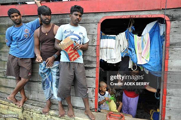 To go with Australia-Indonesia-immigration-refugees-SriLanka by Arlina Arshad Sri Lankan asylum-seeker Brenda talks to journalists as men fish from...