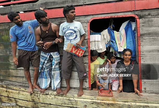 To go with Australia-Indonesia-immigration-refugees-SriLanka by Arlina Arshad Sri Lankan asylum-seeker Shanti talks to journalists as men fish from...