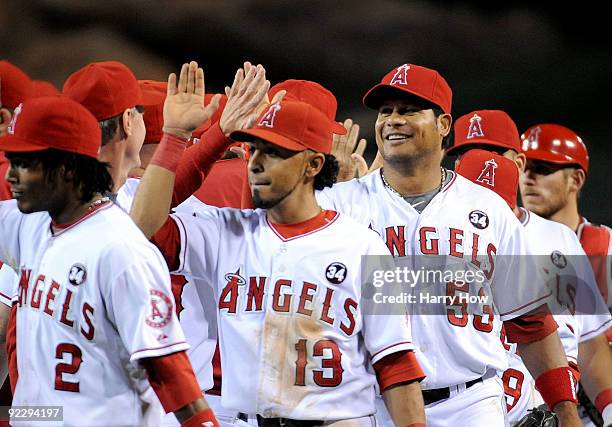Maicer Izturis of the Los Angeles Angels of Anaheim celebrates with teammates after defeating the New York Yankees 7-6 in Game Five of the ALCS...