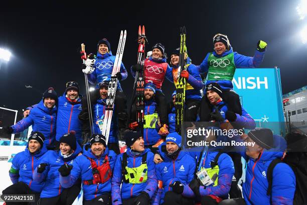Bronze medalists Anais Bescond, Anais Chevalier, Justine Braisaz and Marie Dorin Habert of France celebrate with team mates and coaches after the...