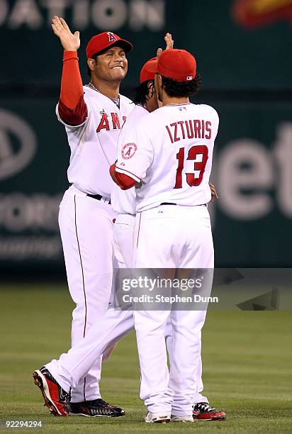 Bobby Abreu of the Los Angeles Angels of Anaheim celebrates with teammate Maicer Izturis after defeating the New York Yankees 7-6 in Game Five of the...