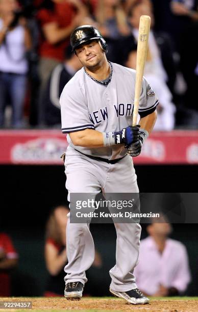Nick Swisher of the New York Yankees reacts after popping out, ending the ninth inning of Game Five of the ALCS against the Los Angeles Angels of...