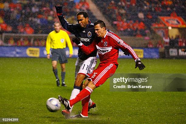 Marco Pappa of the Chicago Fire and Maykel Galindo of Chivas USA go for the ball during the first half at Toyota Park on October 22, 2009 in...